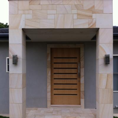 Sawn finish sandstone cladding to the entry facade