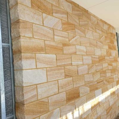 Rock faced sandstone block wall