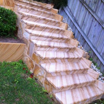 Medium brown rock faced edge sandstone staircase & flagging cladding