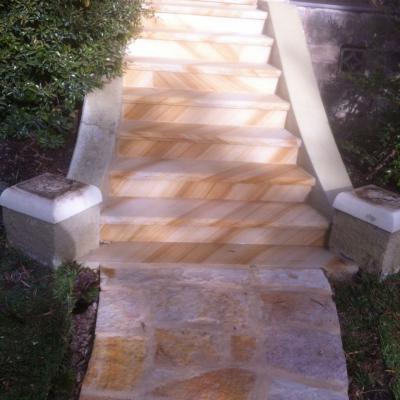 Rock faced edge sandstone staircase & flagging pathway