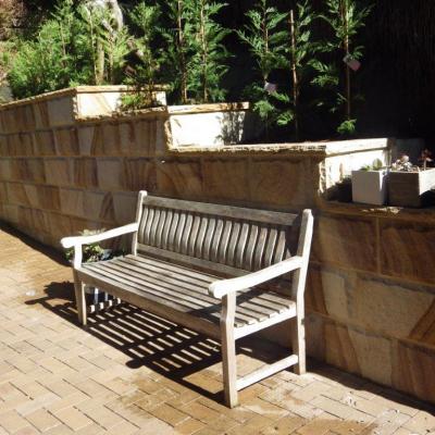  Stepped  rock faced sandstone block  retaining wall & 50mm high coping in medium brown