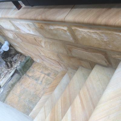 Sandstone bullnosed edge step thread & sandstone wall cladding completed with bullnosed sandstone coping