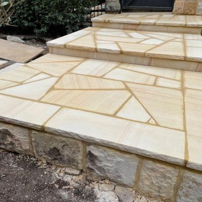 Medium brown crazy pattern sandstone landing with rock faced edge